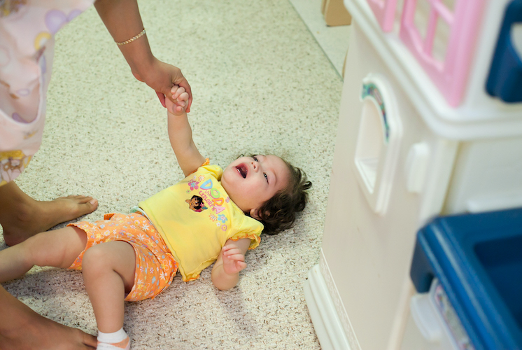 Toddler laying on the floor