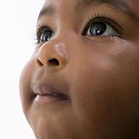 a close-up picture of a toddler looking up