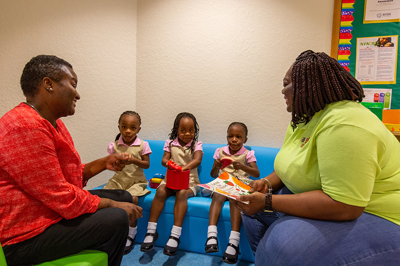 Two teachers reading to children