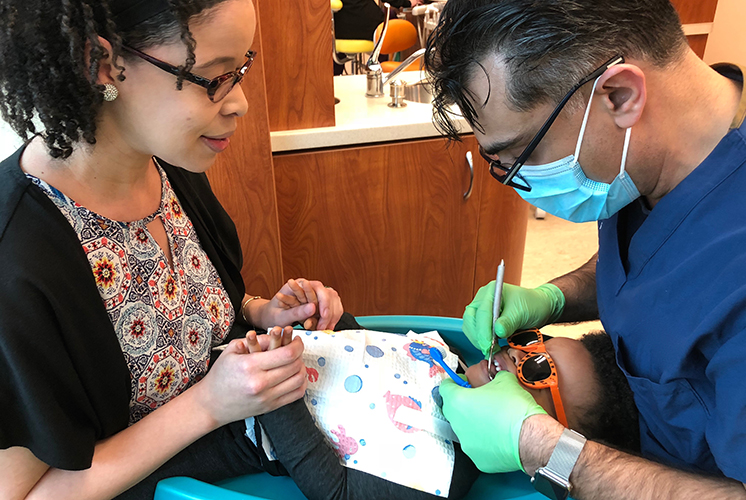 A child at dentist exam with parent