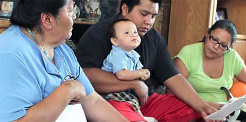 Home visitor with a mother, father, and son