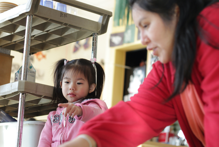 Woman and little girl pointing at something