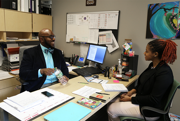 a woman and man talk in an office