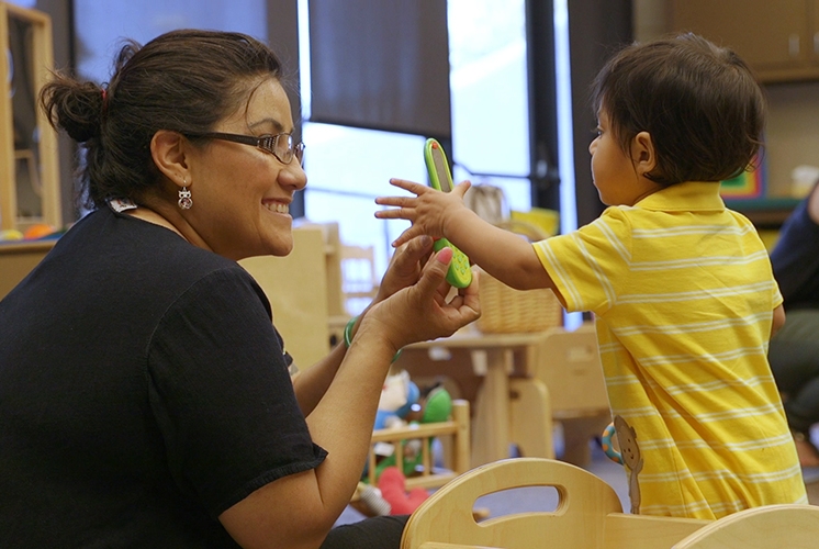 teacher playing with toddler