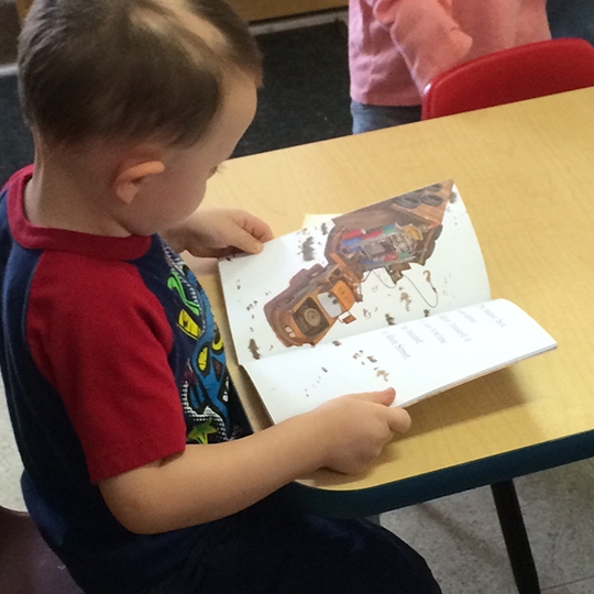 Boy reading at library 