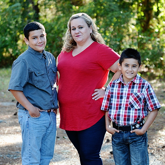 Kay Dease with her sons outside