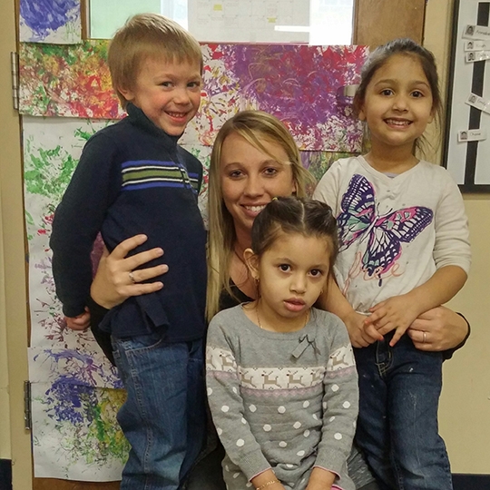 Tracey Stone with three Head Start kids